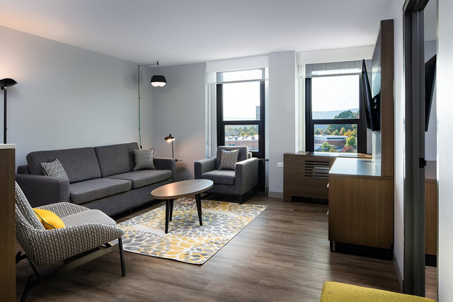 Hotel guestroom featuring decorative wall art with integrated LED picture lights
