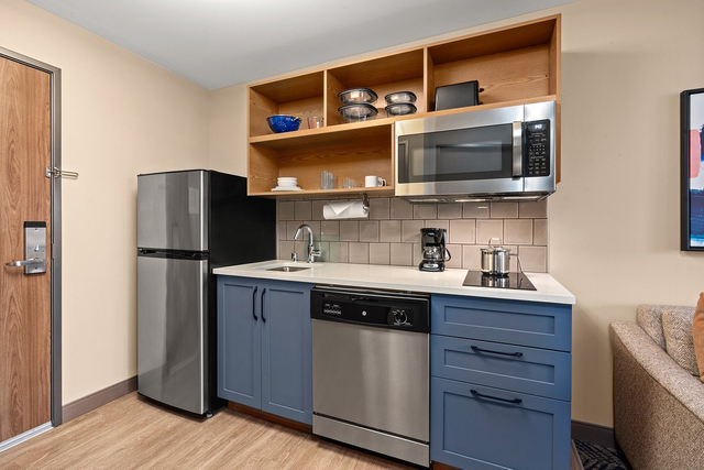 Fully equipped kitchenette with energy saving LED under cabinet lights and appliances
