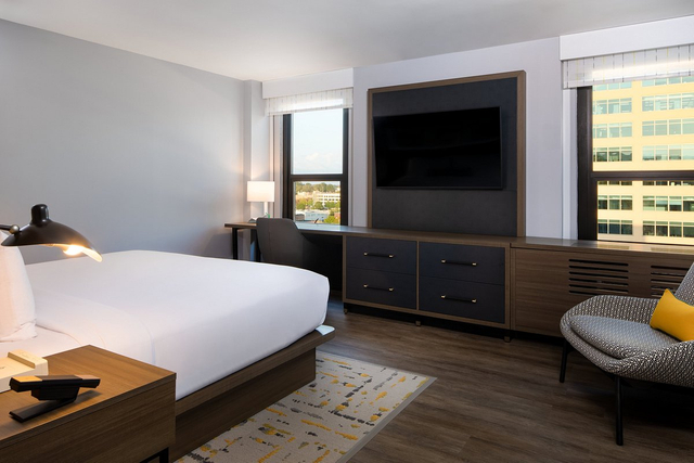 Accessible hotel guestroom bathroom featuring barrier free LED lighting and fixtures
