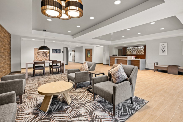 Extended stay hotel lobby with custom LED ceiling fixtures and contemporary seating lounge