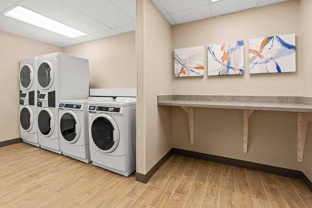 Guest laundry facility with commercial LED overhead lights and energy efficient washers