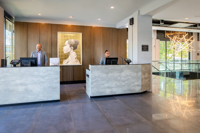 Hotel front desk reception area with polished concrete and commercial LED lighting
