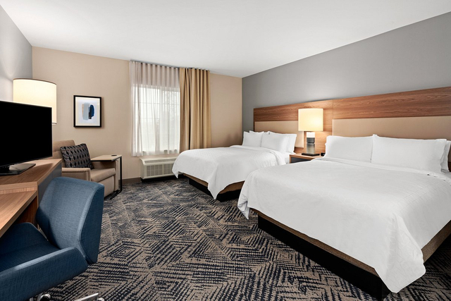 Two queen bed studio suite featuring commercial grade LED ceiling lights and bedside lamps