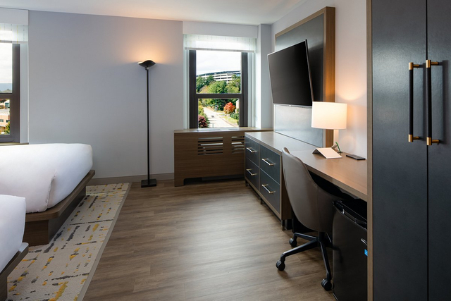 ADA compliant hotel bathroom with wheelchair accessible lighting controls and grab bars