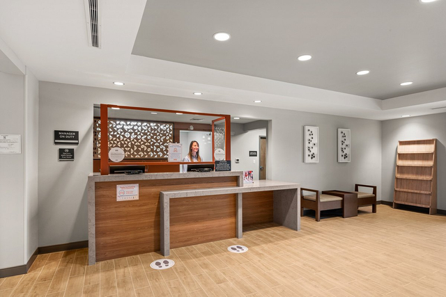 Candlewood Suites hotel front desk reception featuring warm white LED recessed downlights