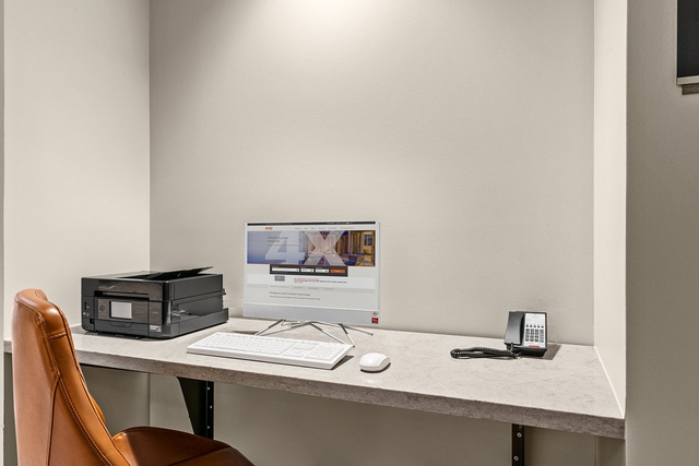 Business center workstation with LED desk lamps and USB ports for guest productivity